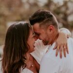 A joyful couple embracing outdoors, capturing intimate and happy moments together in summer.